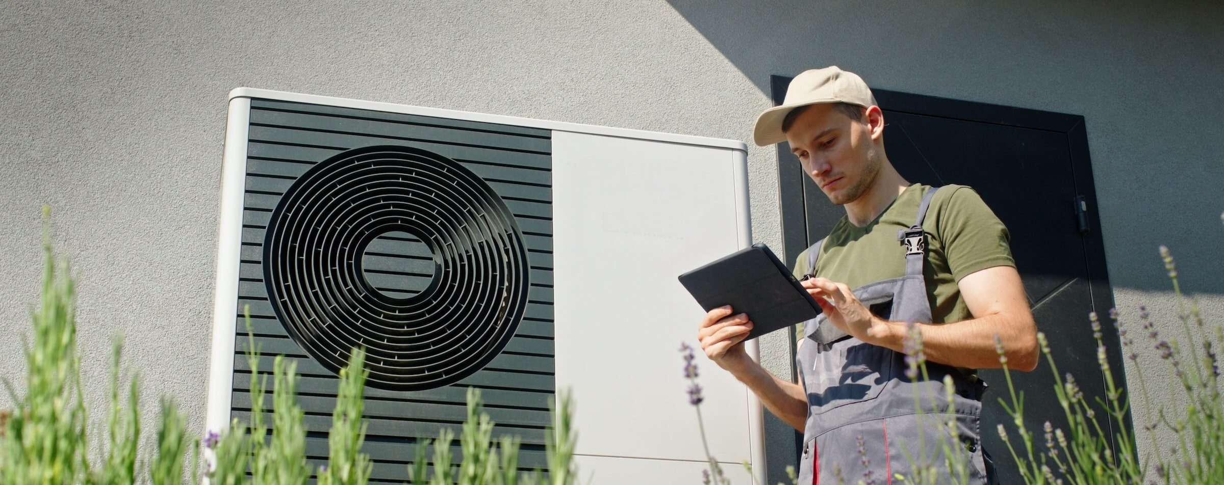 Heat Pump Contractor Looking At Installation Details For New Heat Pump